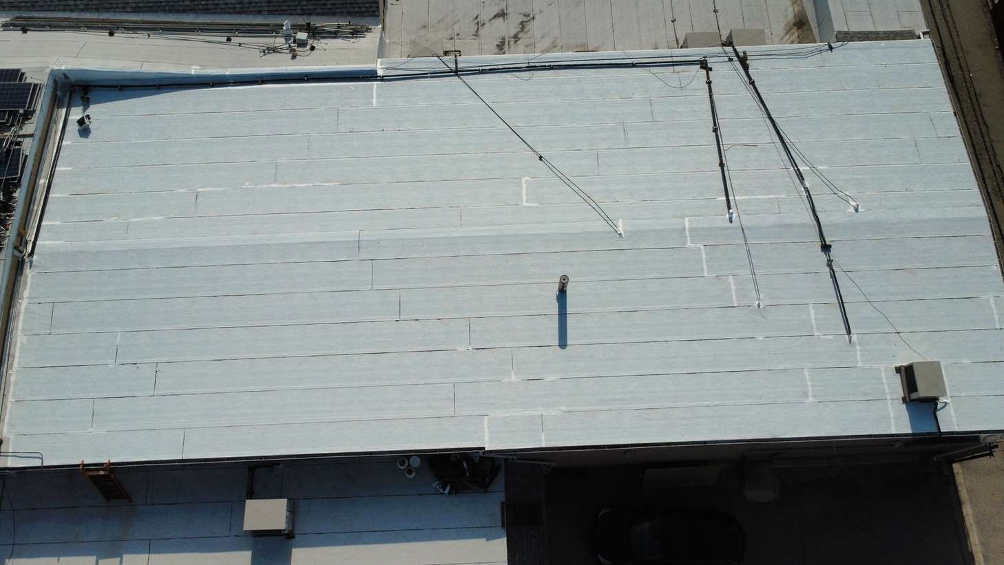 Overlapping roof sheets and pipe penetrations viewed from above